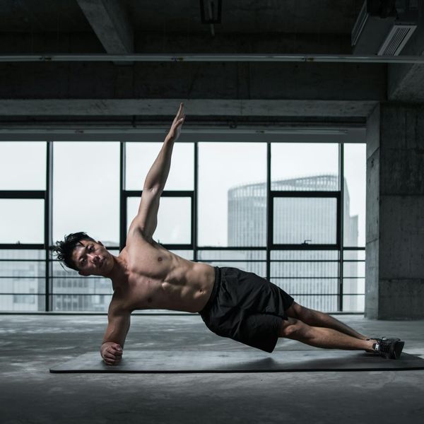 Close-up of a man performing core stabilizing plank exercise.